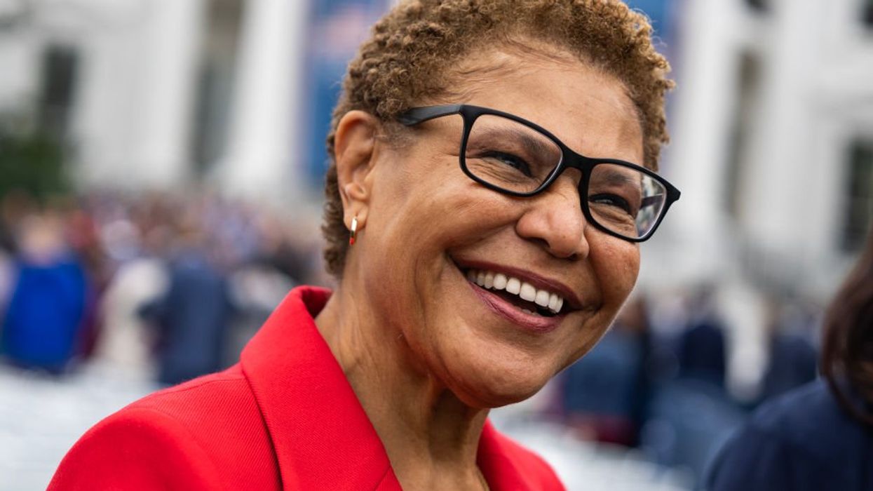 Karen Bass was enjoying a cocktail party, taking photos in a foreign land while her city burned
