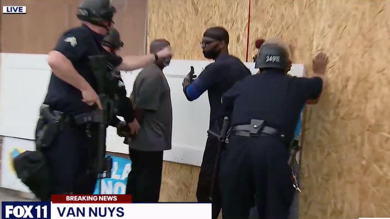 LAPD detains armed business owners on live TV. The owners were just trying to protect their stores.