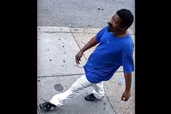 Laughing 'piece of s**t' thug caught on video punching victim in face as pair pass each other in Philly crosswalk