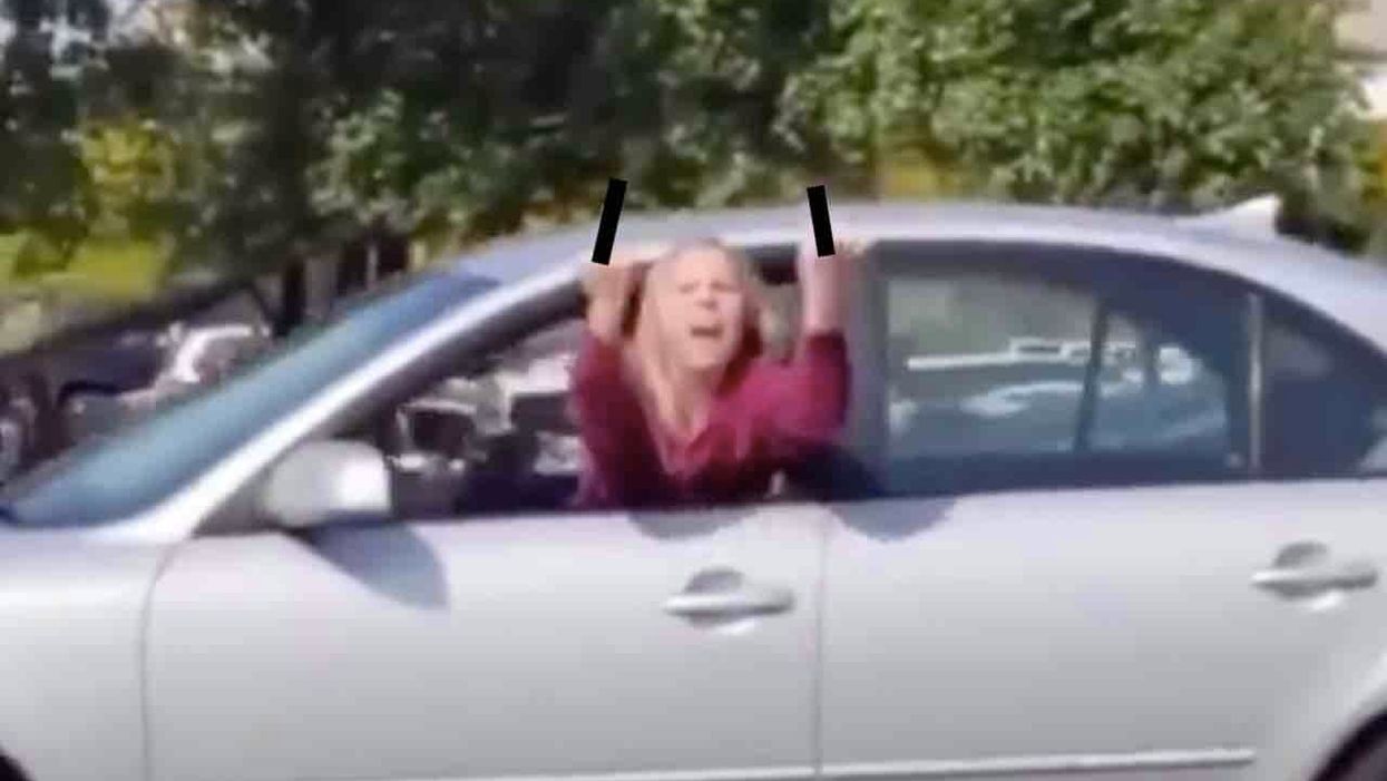 Leftist leans half her body out car window amid traffic to flip off Trump fans. Then cops pay her a visit — and much glee ensues.