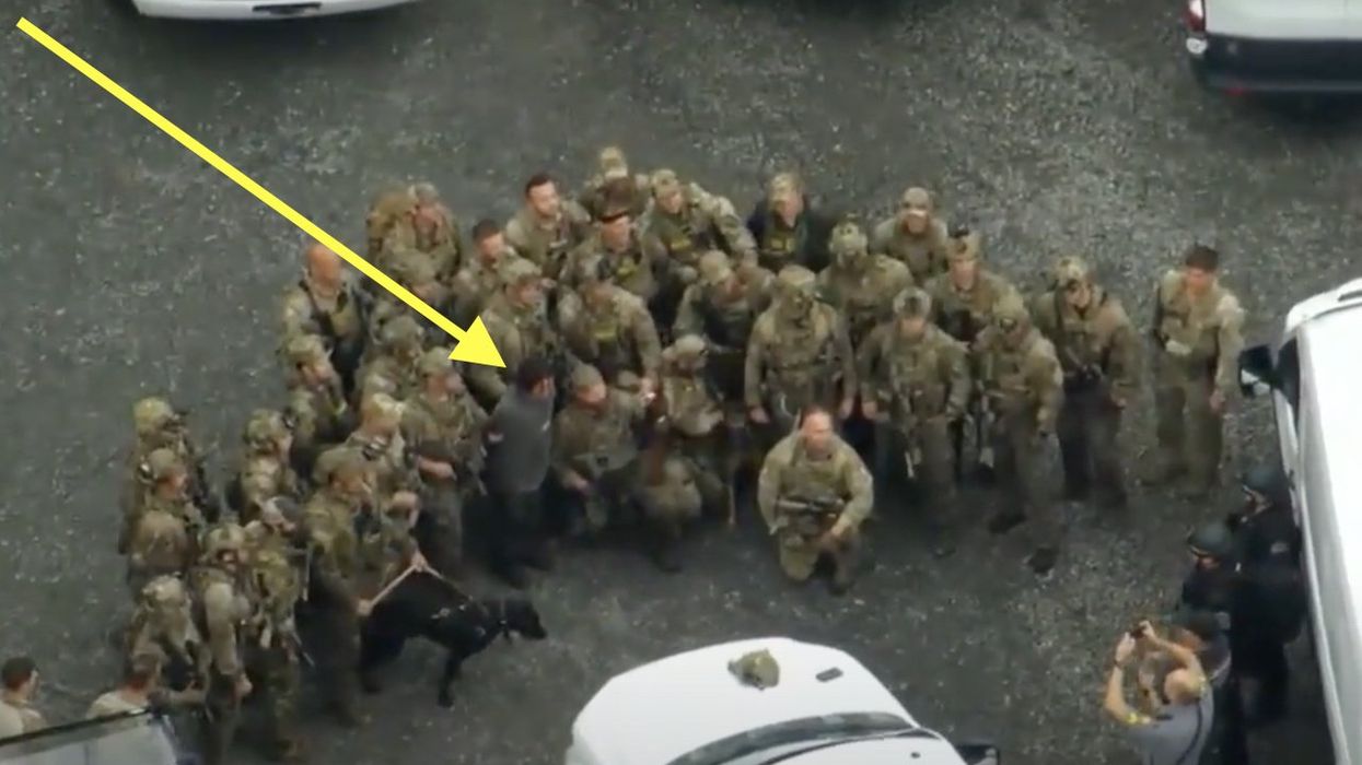 Leftists cry foul over 'photo op' of law enforcement around captured illegal alien fugitive — a convicted killer. But state cop shoots them all down.