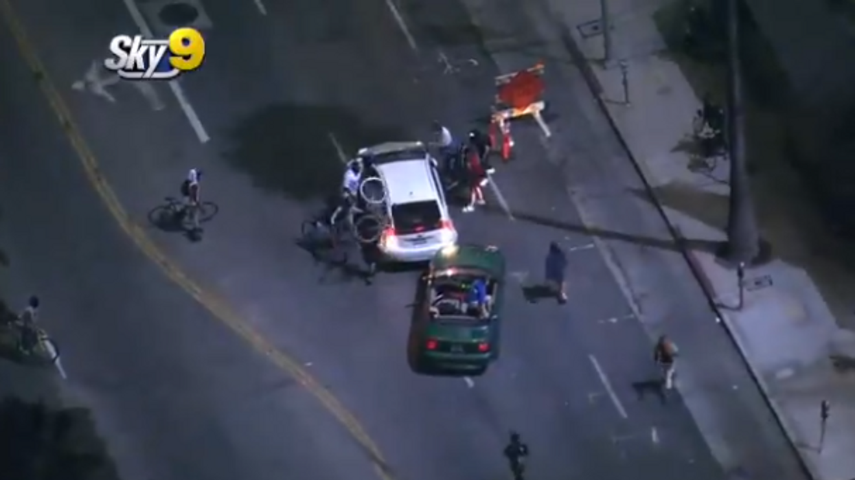 Man drives through protest in a Prius, gets chased down by cars and attacked by protesters