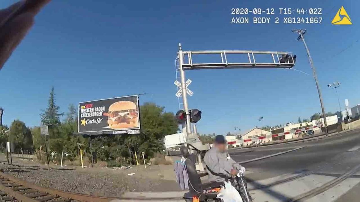 Man in wheelchair on railroad tracks
