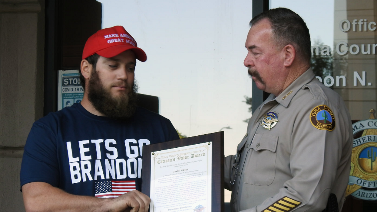 Marine Corps veteran who stopped armed robbery accepts valor award wearing 'Let's Go Brandon' shirt and a MAGA hat