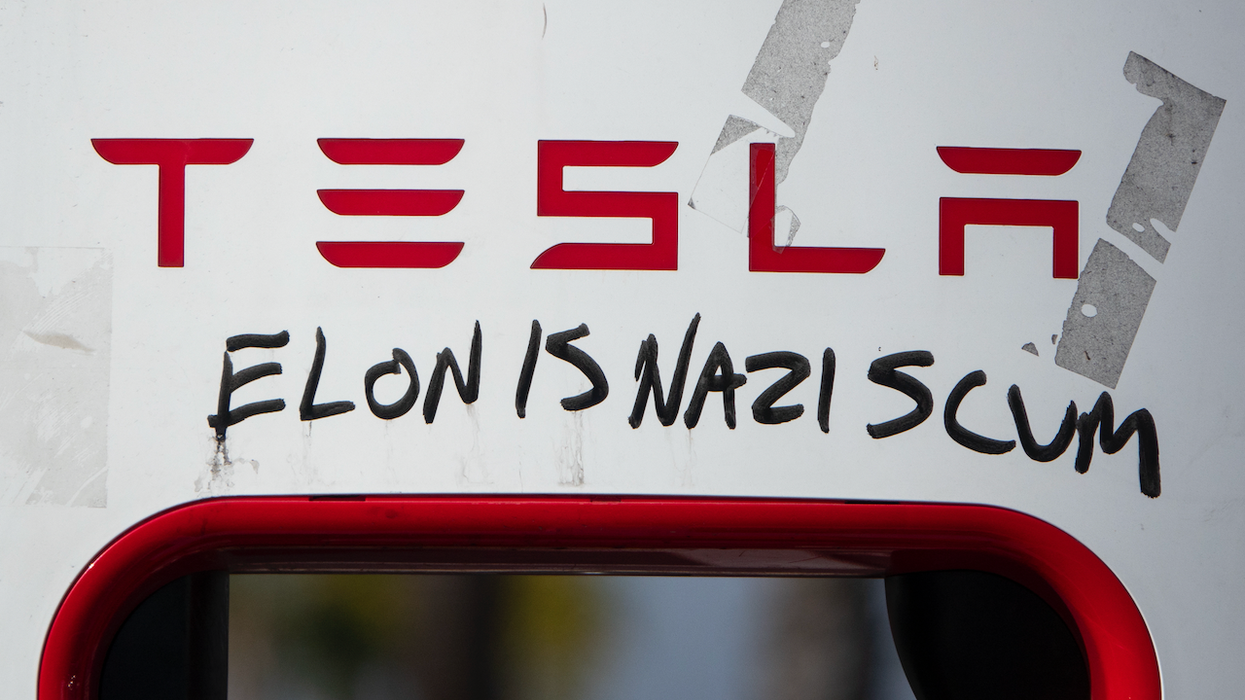 Masked leftist thug cuts off, harasses Tesla driver — a mother on her way to doctor — and tells her, 'This is a Nazi car'