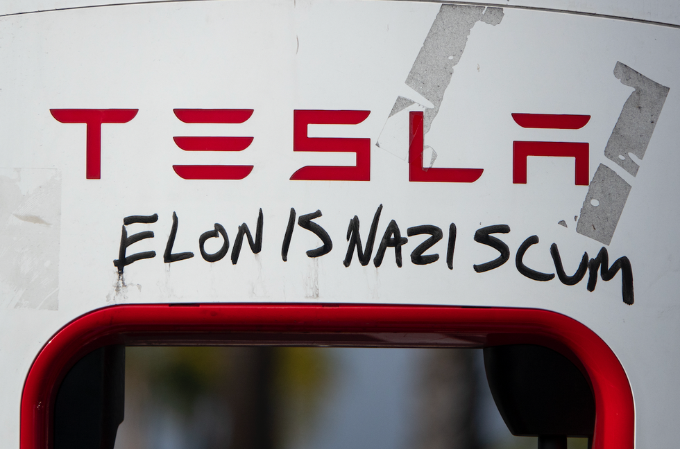 Masked leftist thug cuts off, harasses Tesla driver — a mother on her way to doctor — and tells her, 'This is a Nazi car'