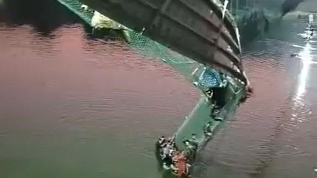 Men seen in CCTV footage violently shaking Indian suspension bridge moments before its horrific collapse — at least 133 dead