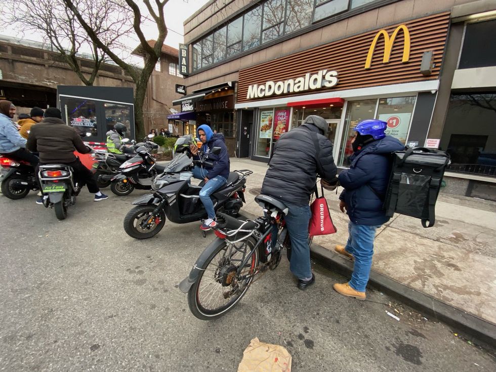 Migrant workers take over block in NYC with e-bikes for food delivery and night watchman, 'shocked' locals say