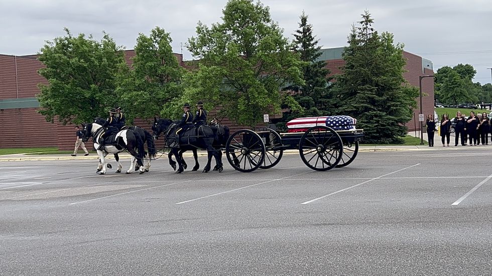Minneapolis mayor gets cold shoulder from police as family and friends honor fallen officer
