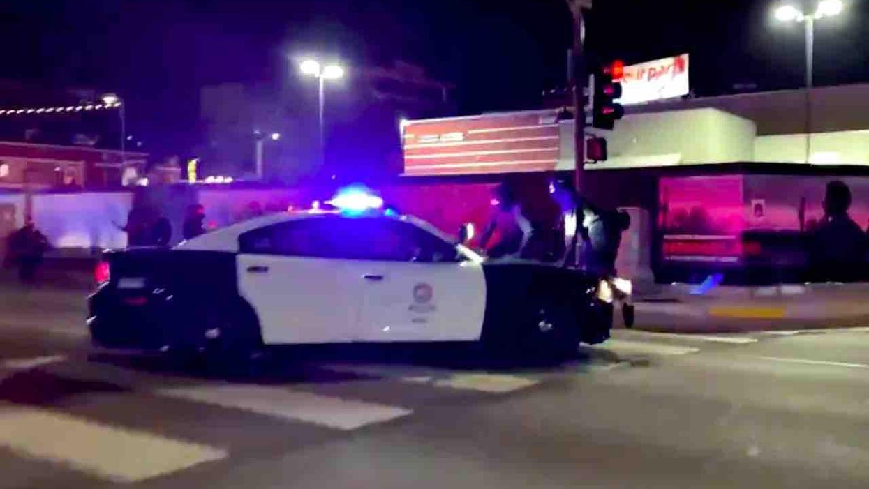 Newsweek headline says cop car 'strikes' protesters at L.A. march — but video in magazine's own story appears to indicate otherwise