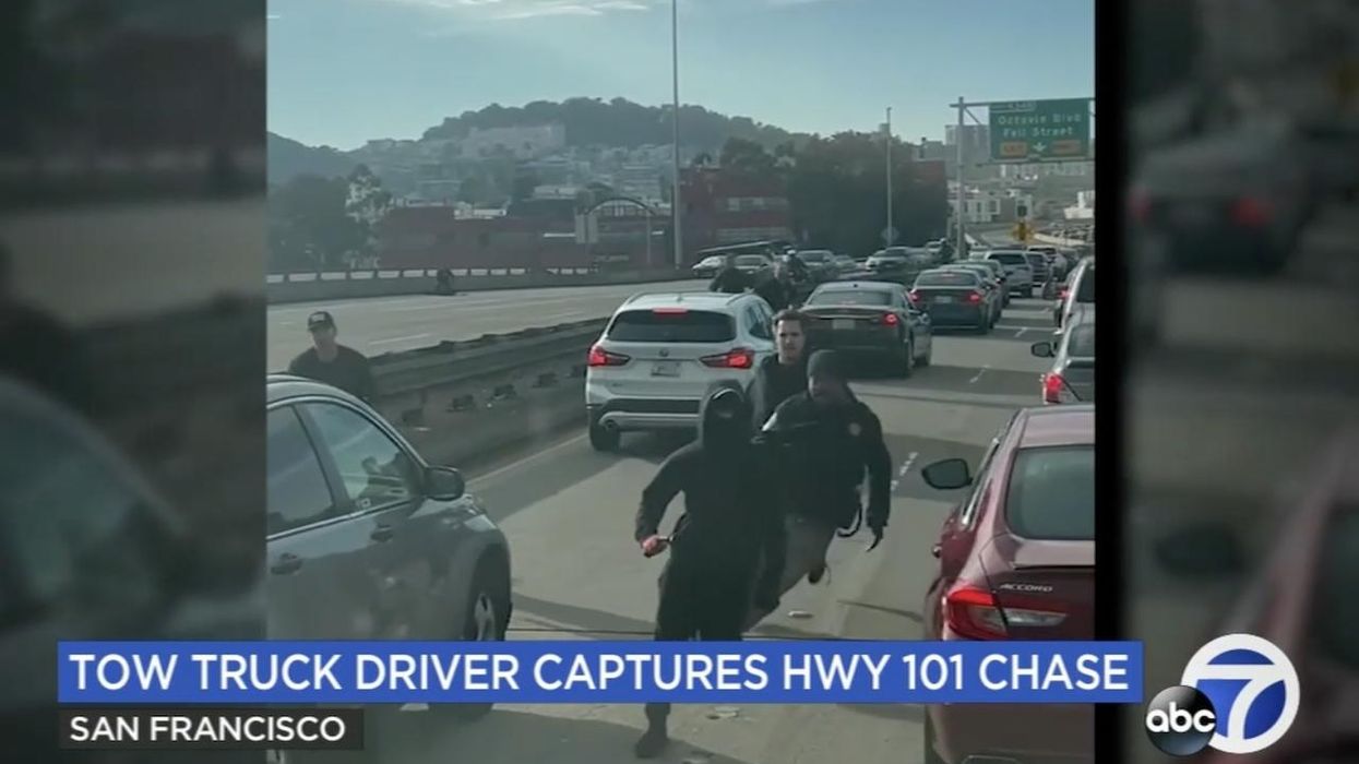 No, it's not a scene from a new 'Dirty Harry' movie: Real-life suspected car burglars caught on video running from cops across San Francisco freeway