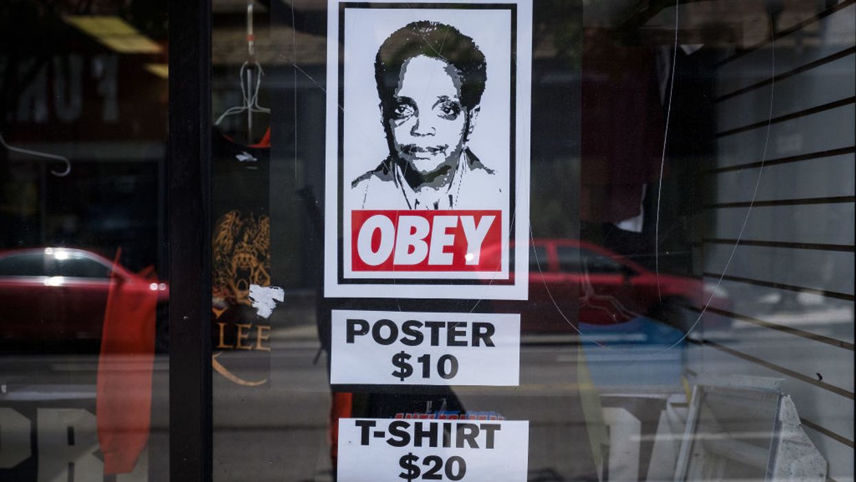 'OBEY' poster  in shop window showing Chicago Mayor Lori Lightfoot