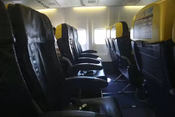 Passenger partially sucked out of window during plane flight — his wife and others held on to him