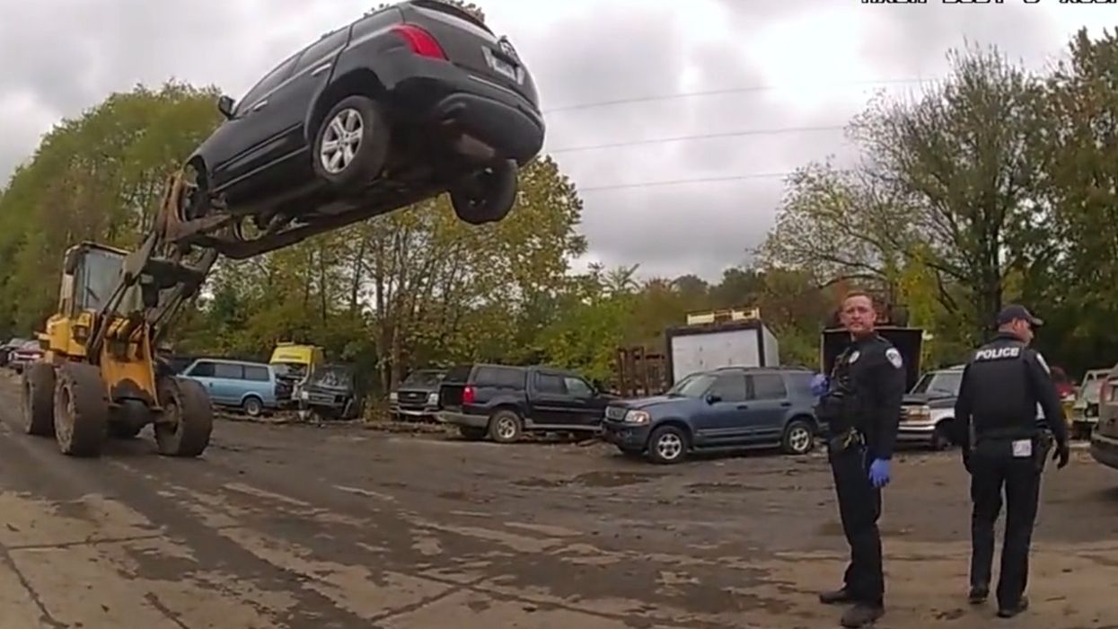 Police arrive to find criminal hoisted 20 feet above junkyard: 'I refuse to drop this thing to let him out and run'