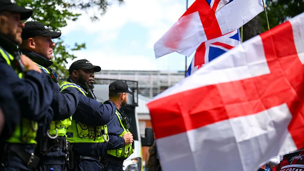 Police drag away a man for saying he likes bacon near a sprawling mosque construction site