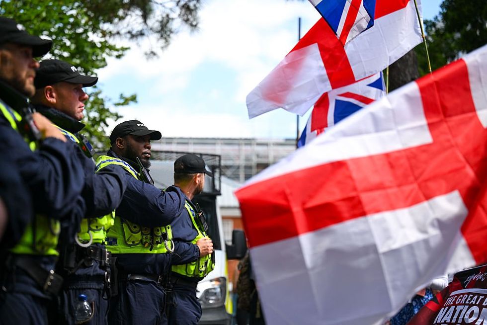 Police drag away a man for saying he likes bacon near a sprawling mosque construction site