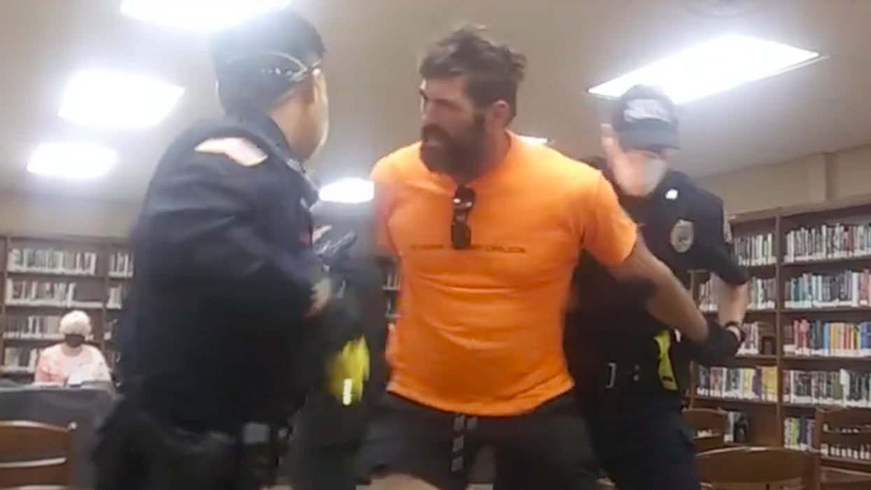 Police haul man out of school board meeting about mask mandates for not wearing a mask