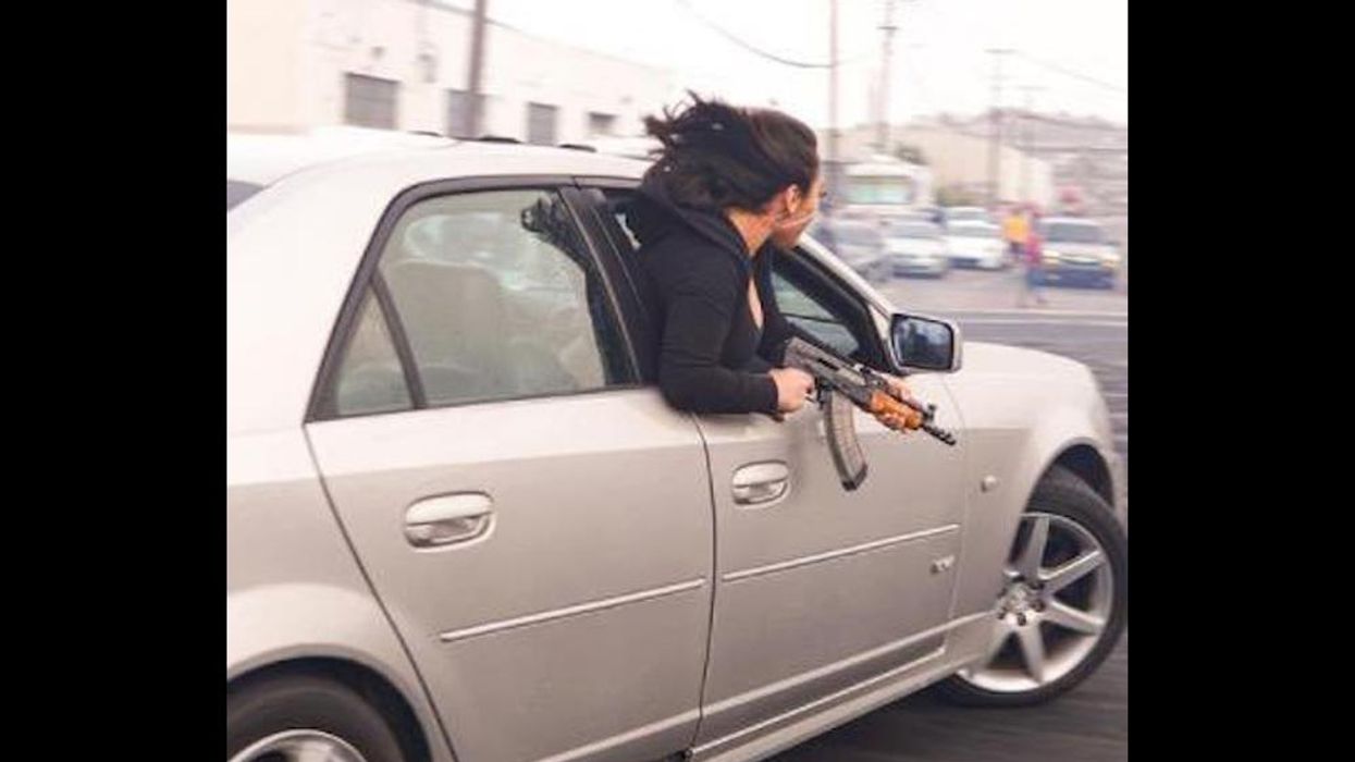 Police photo shows woman leaning out of car window with AK-47 during illegal 'sideshow' in lawless San Francisco