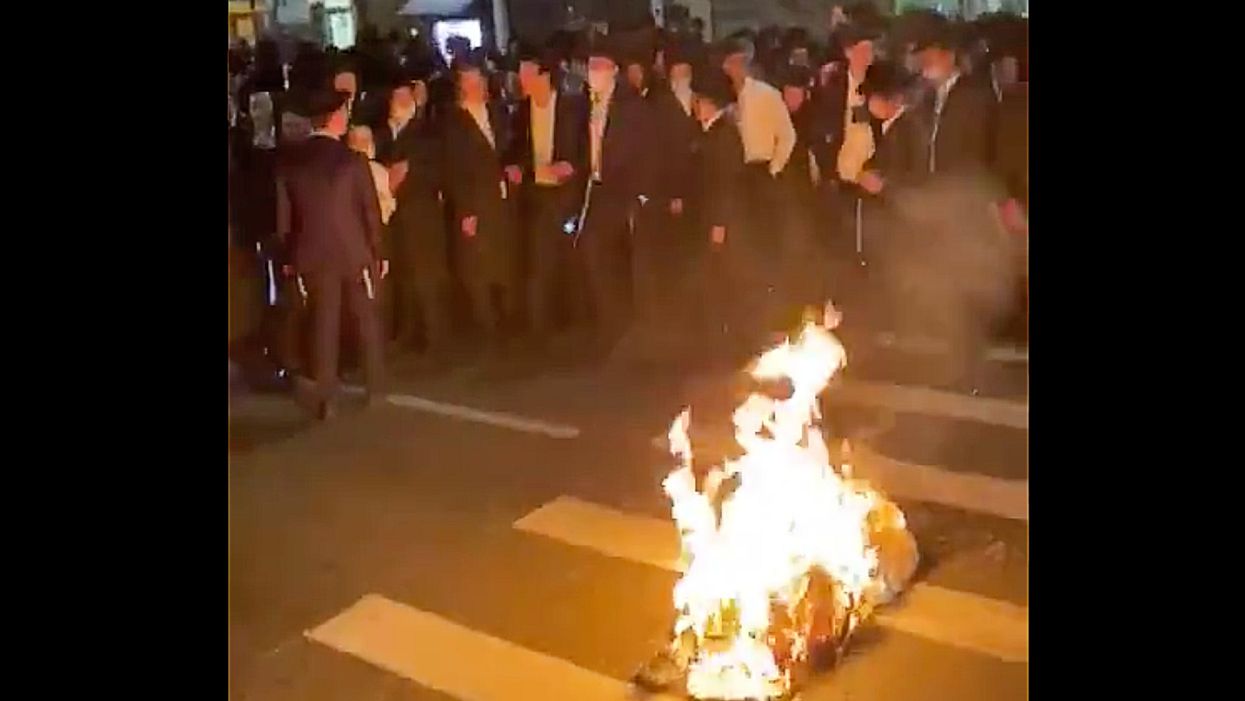 Police try to shut down celebration during Jewish holiday. Cuomo issues new 'draconian' measures, and community comes together to burn masks in the street.