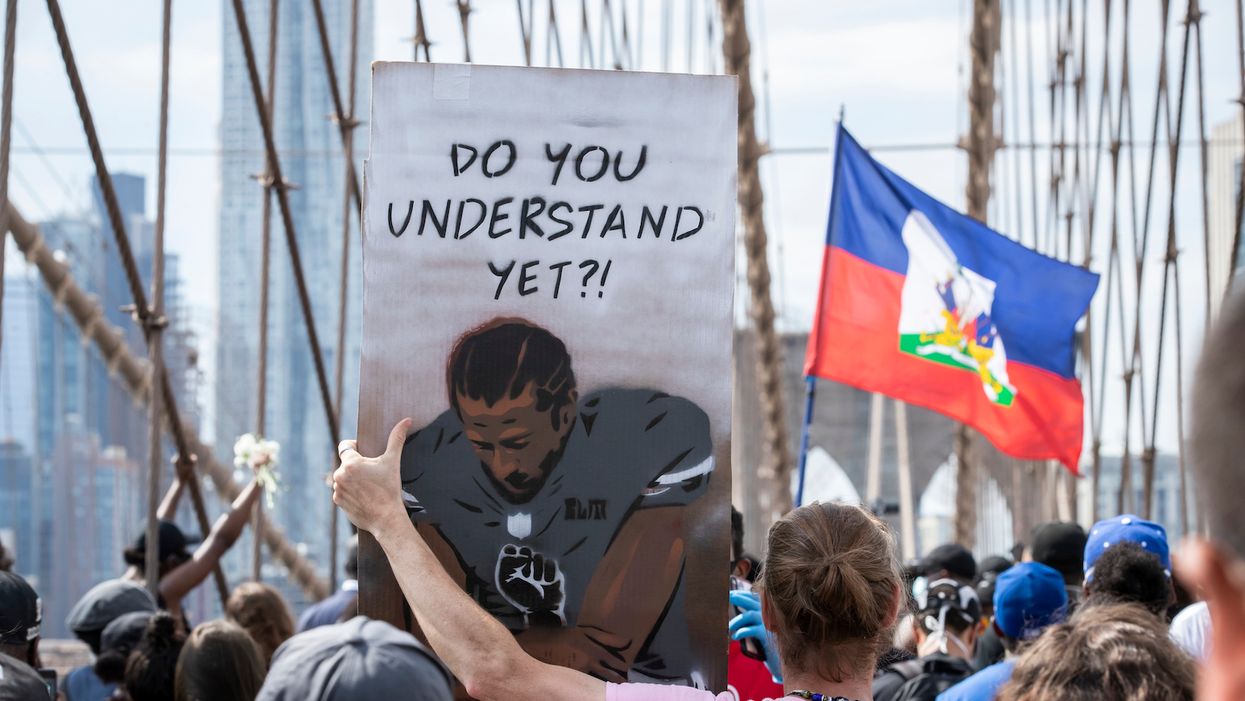 Protester holding Colin Kaepernick sign