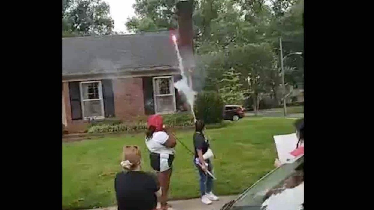 Protesters shoot fireworks toward district attorney's home on July 4, block streets, burn US flag