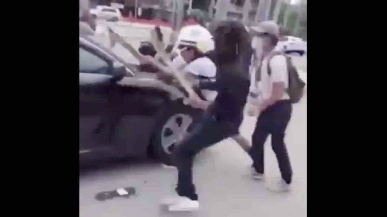 Protesters smash windshield of police car, attack officers in street. Cops aren't about to retreat.