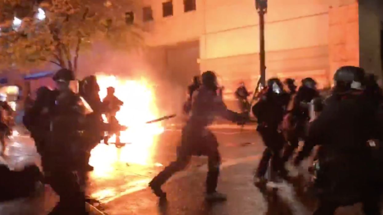 Rioter throws Molotov cocktail at group of police officers, striking one, as mob sets fire to justice center following Breonna Taylor indictment