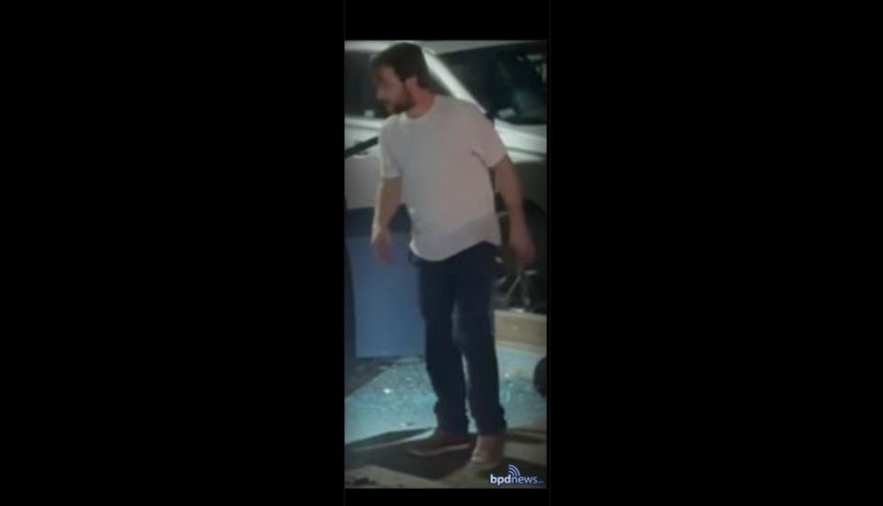 Road-rage suspect uses hatchet to repeatedly smash windows of crashed car — and the act is ​caught on cellphone video