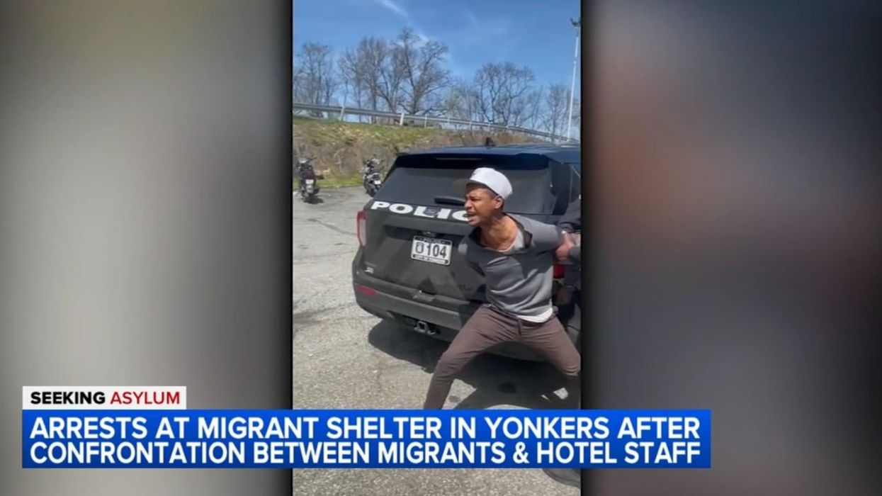 Rowdy migrants scuffle with police at New York hotel shelter after employee calls 911 on 'very violent' asylum-seeker
