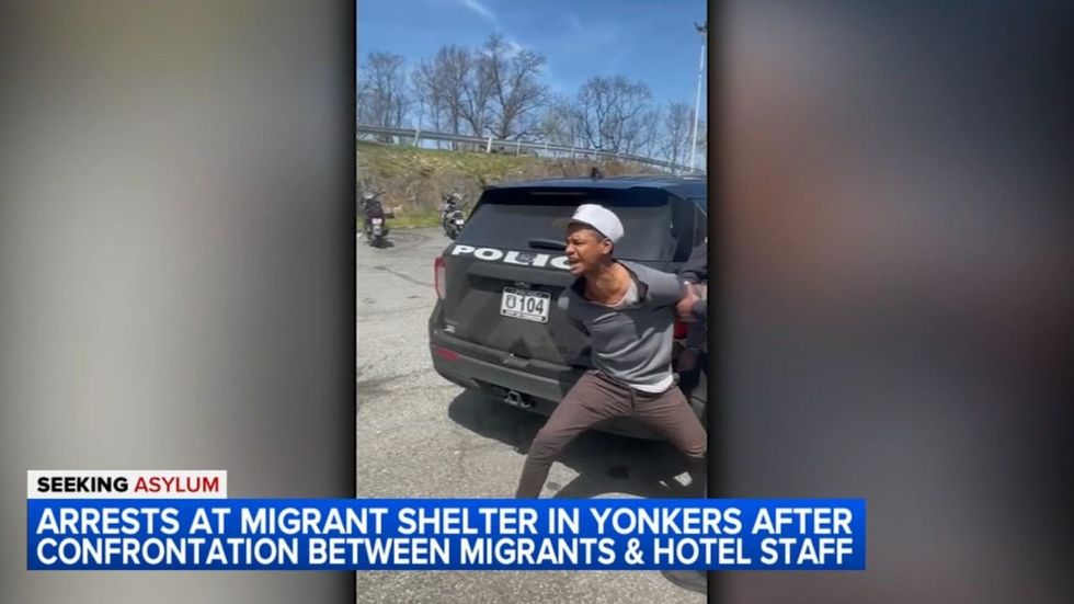 Rowdy migrants scuffle with police at New York hotel shelter after employee calls 911 on ';very violent'; asylum-seeker