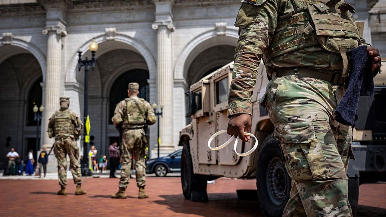 Scooter-riding leftist lawyer allegedly spits on National Guard troops patrolling DC streets