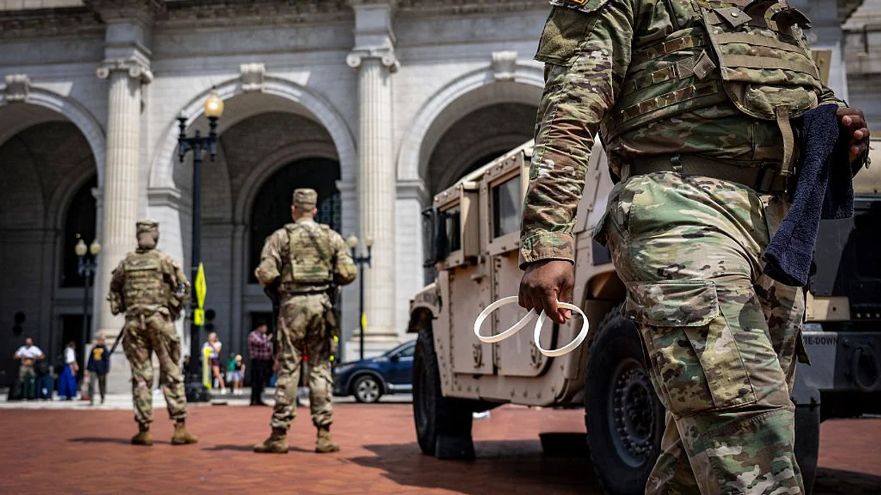 Scooter-riding leftist lawyer allegedly spits on National Guard troops patrolling DC streets