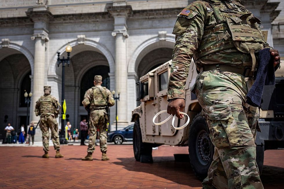 Scooter-riding leftist lawyer allegedly spits on National Guard troops patrolling DC streets