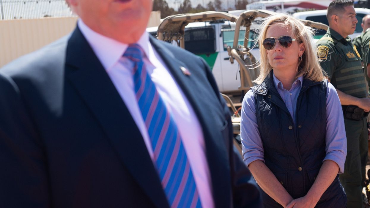 Secretary of Homeland Security Kirstjen Nielsen stands alongside US President Donald Trump as he tours the border wall between the United States and Mexico in Calexico, California on April 5, 2019.