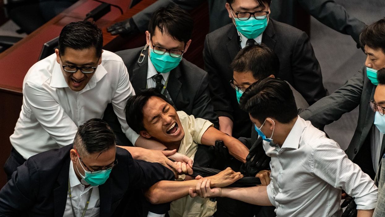 Security drags pro-democracy lawmakers from Hong Kong legislature in order to install pro-China leadership
