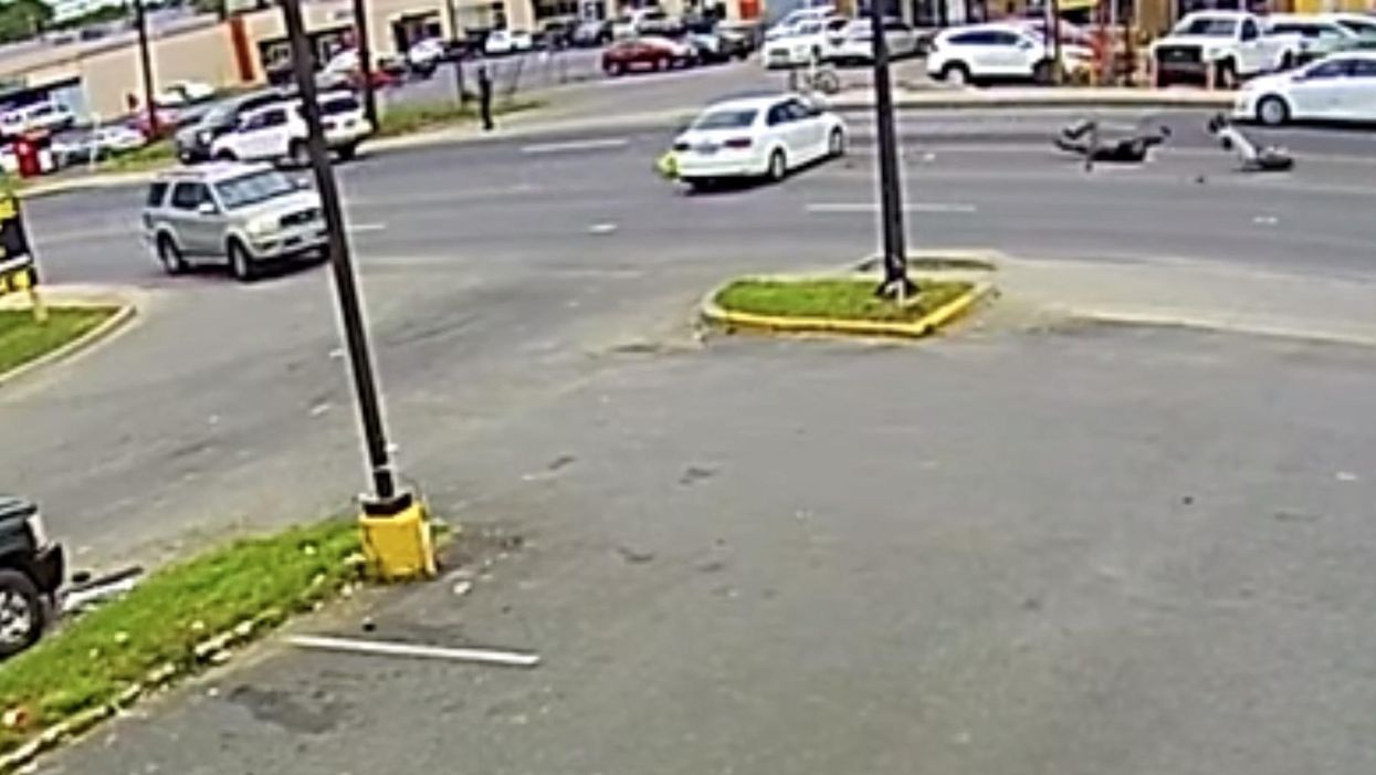 Security video captures 2 hurt in brutal motorcycle crash after car pulls out into busy traffic, flees the scene