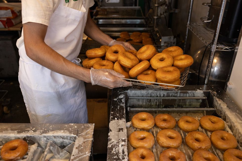 Security video shows workers fighting off man in bikini trying to rob donut shop