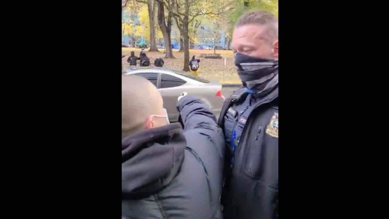 'Shut the f*** up, b***h!': Black Lives Matter militant gets in cop's face amid Portland street showdowns