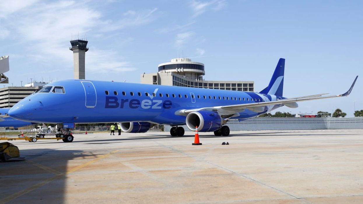 'Sit your a** down': Crazy video shows hulking 'linebacker' stifling unruly passenger hurling slurs, later waving skateboard