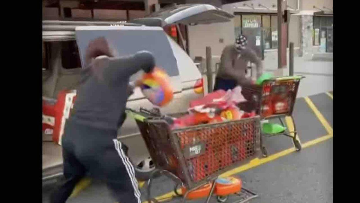Supermarket thieves pull off 'organized' heist as onlookers watch, record video. Even license plates were removed from likely stolen SUVs used in broad-daylight caper.