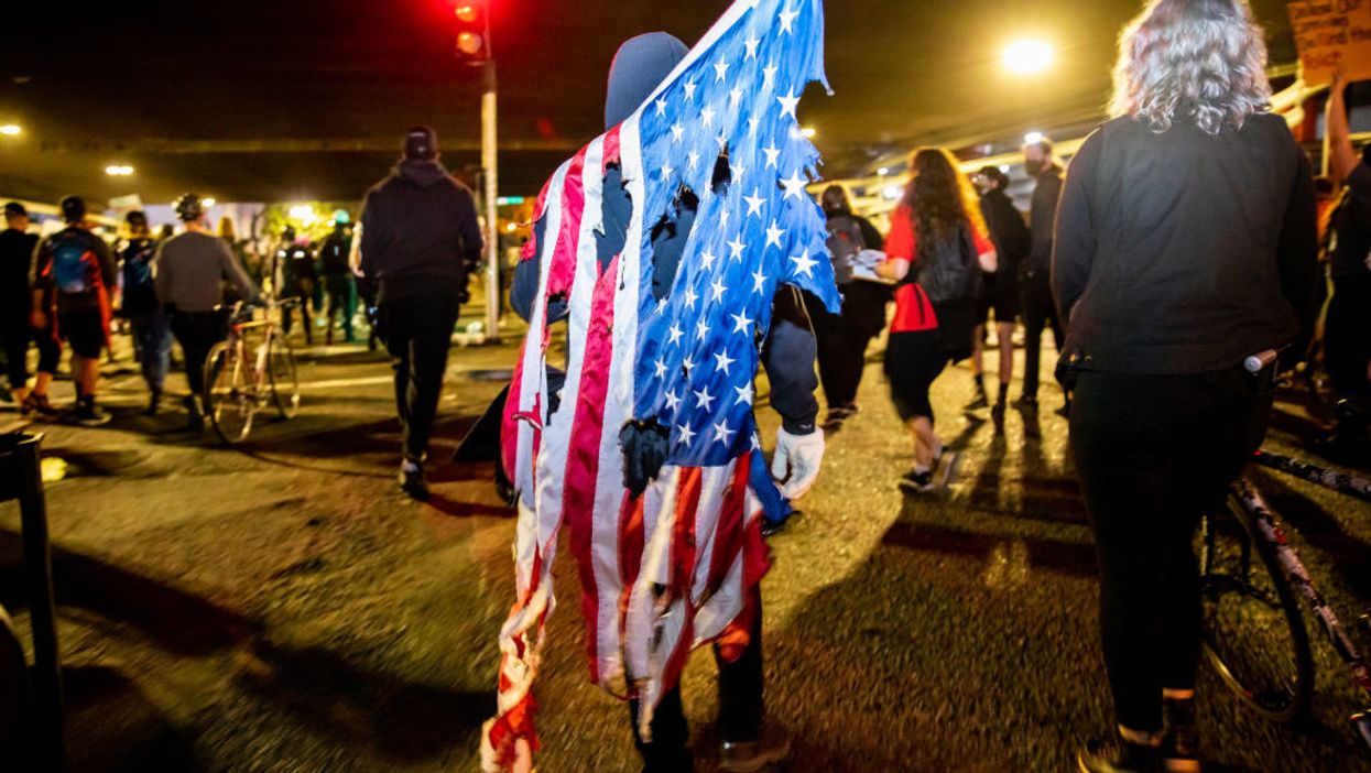 Tattered American flag held by rioters