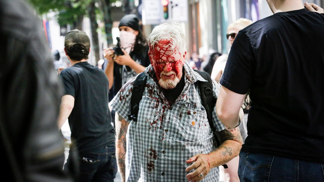 The Rose City Antifa brutally attacks an unidentified right aligning man at Pioneer Courthouse Square on June 29, 2019 in Portland, Oregon. Several groups from the left and right clashed after competing demonstrations at Pioneer Square, Chapman Square, and Waterfront Park spilled into the streets. According to police, medics treated eight people and three people were arrested during the demonstrations.