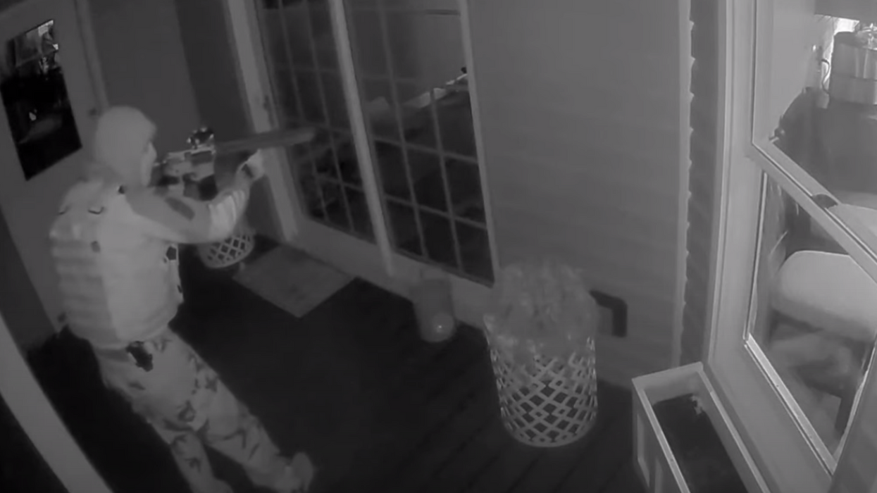 'There’s somebody at our back door with a gun': Scary home video shows camouflaged intruder seemingly forgot to load his gun