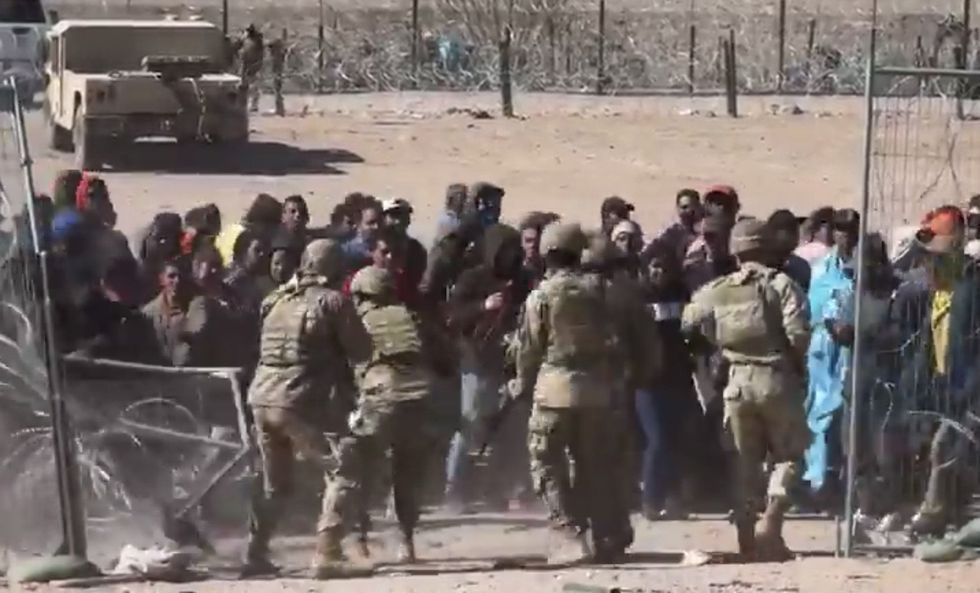 'This is an invasion': Shocking video footage shows mob of angry migrants breach border‚ rush National Guard soldiers