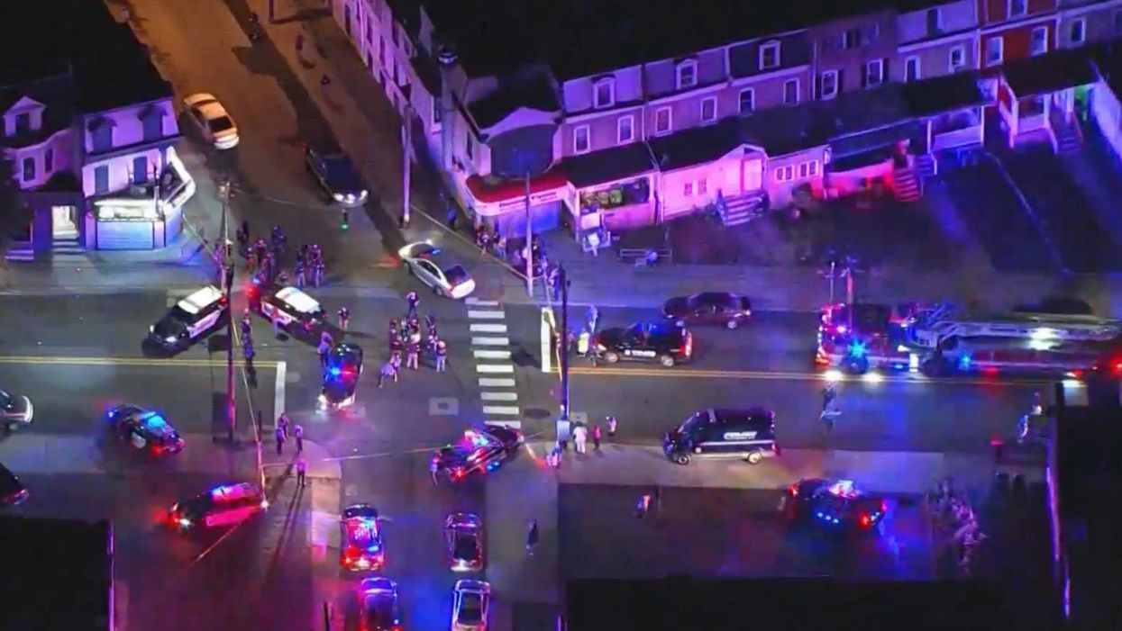 Three Delaware cops shot during standoff. Activist says residents were screaming profanities at officers as they carried injured away.