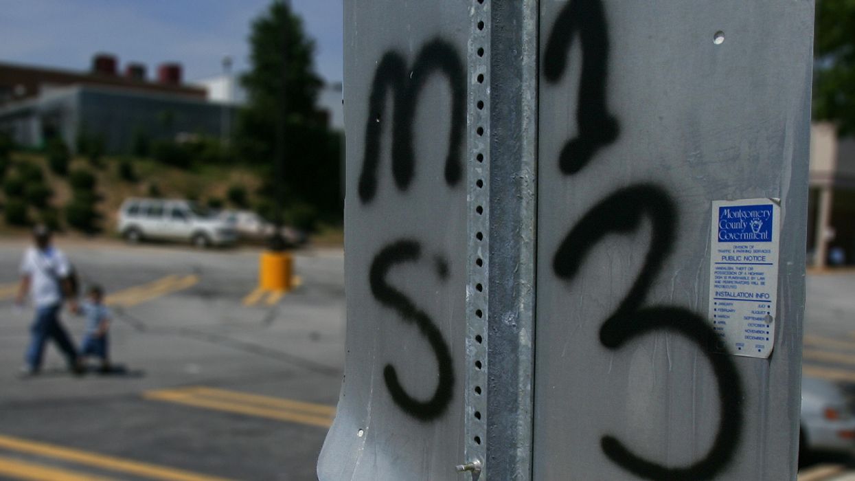 Traffic sign tagged to mark territory for the El Salvaldorian gang MS13 in the Washington, DC, suburb of Silver Spring, Maryland