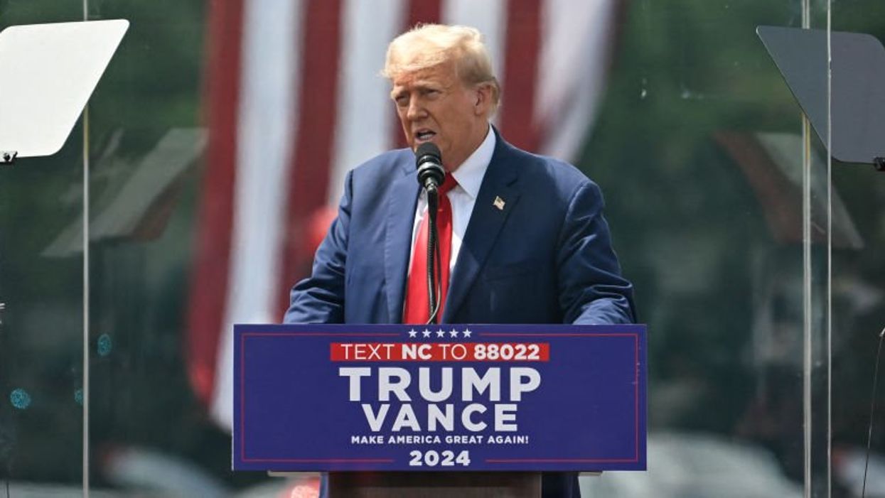 Trump leaves bulletproof glass to check on, hug supporter who fainted at first outdoor rally since assassination attempt