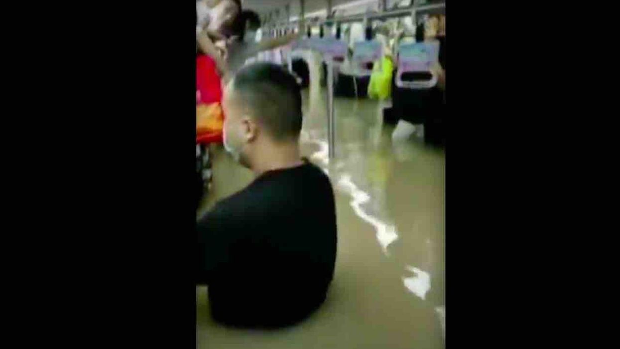 Twelve dead after record-breaking China rains flood railway tunnels; trapped commuters said waters rose from 'our ankles to our knees to our necks'