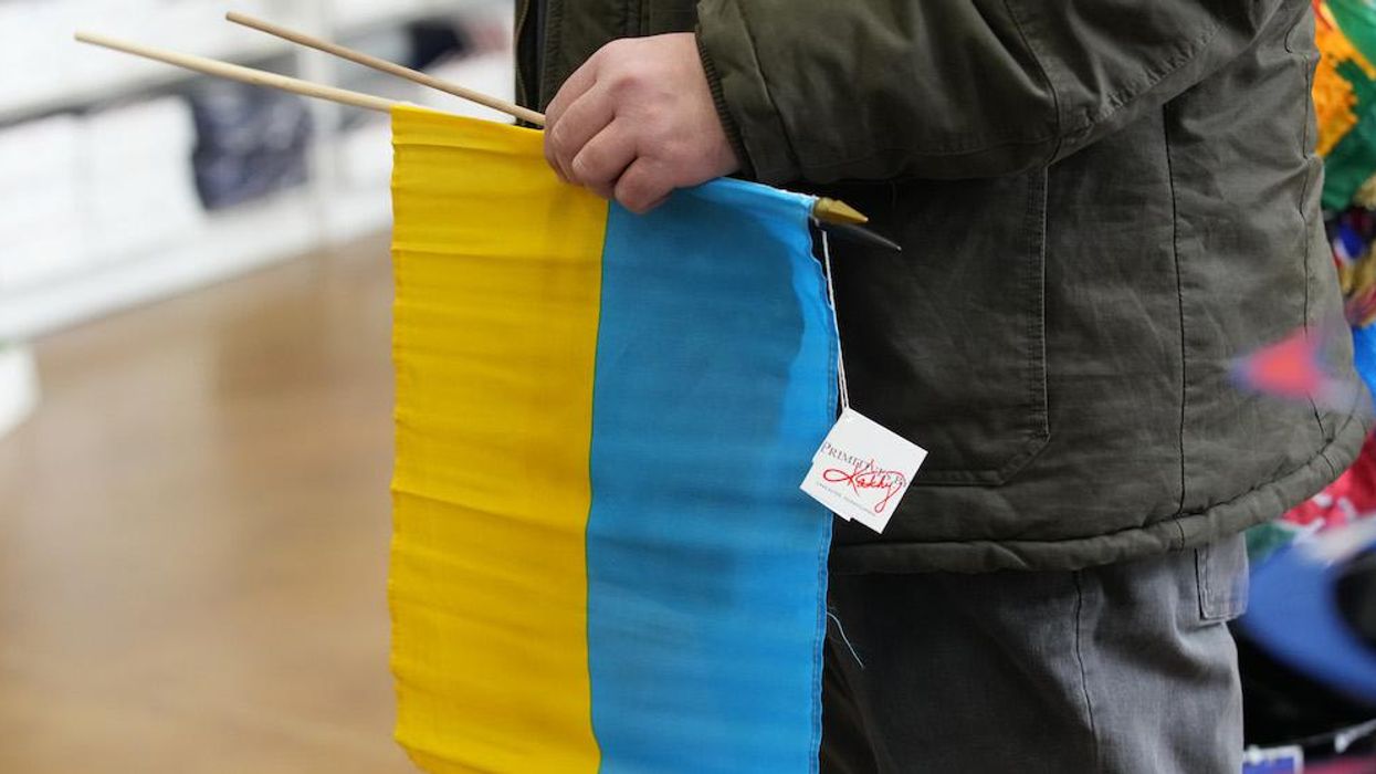 US labor unions declare their support for Ukraine by ... printing signs with the nation's flag upside down. Photos quickly disappear as mockery grows.