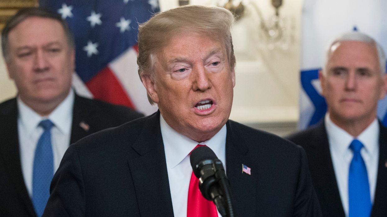 US President Donald J. Trump (C) delivers remarks, flanked by US Secretary of State Mike Pompeo (L) and US Vice President Mike Pence (R), while hosting Prime Minister of Israel Benjamin Netanyahu (unseen) in the Diplomatic Reception Room of the White House March 25, 2019 in Washington, DC. Trump signed an order recognizing Golan Heights as Israeli territory.Netanyahu is cutting short his visit to Washington due to a rocket attack in central Israel that had injured seven people.